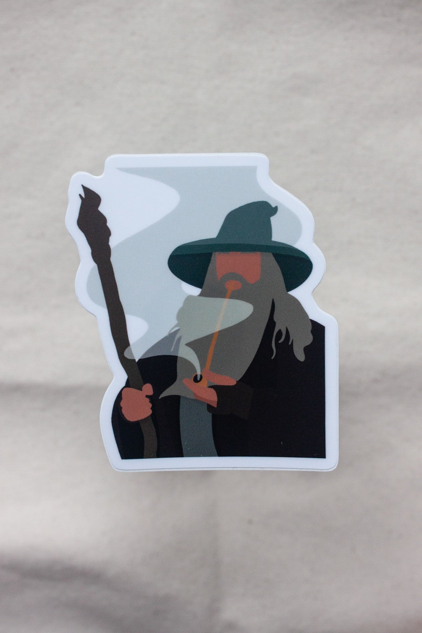 Gandalf the Grey sticker from The Lord of the Rings, depicting the iconic wizard with his staff and cloak, exuding wisdom and power. Perfect for fans of Gandalf and Tolkien’s saga.